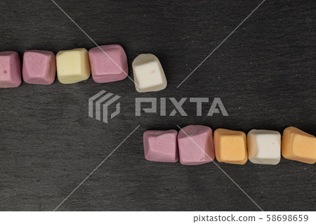 Soft pastel candy on grey stone Soft pastel candy on grey stone 58698659