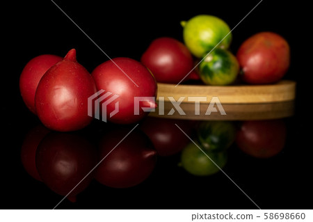 Fresh tomato de barao isolated on black glass 58698660