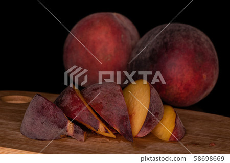 Sweet red peach isolated on black glass Sweet red peach isolated on black glass 58698669