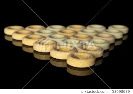 Pale round candy isolated on black glass Pale round candy isolated on black glass 58698689