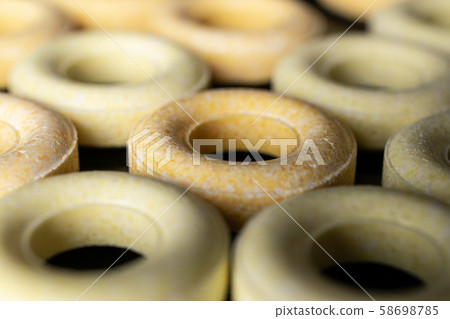Pale round candy isolated on black glass Pale round candy isolated on black glass 58698785