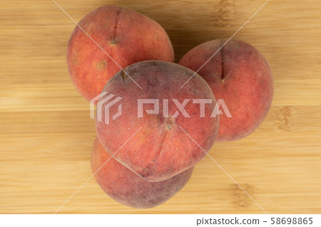 Sweet red peach on light wood 58698865