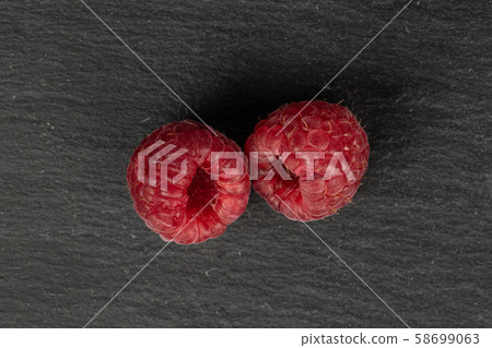 Fresh red raspberry on grey stone Fresh red raspberry on grey stone 58699063