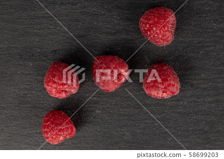 Fresh red raspberry on grey stone 58699203