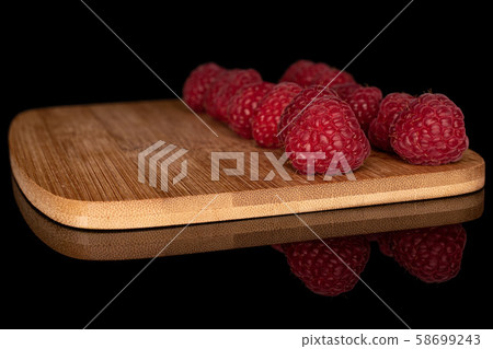 Fresh red raspberry isolated on black glass Fresh red raspberry isolated on black glass 58699243