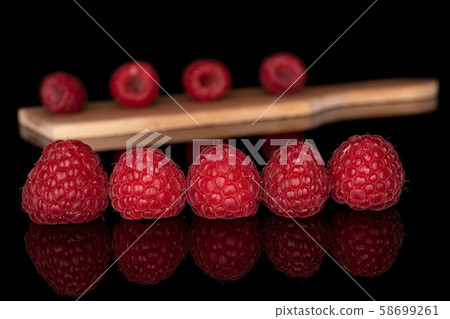 Fresh red raspberry isolated on black glass 58699261