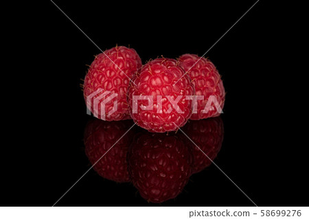 Fresh red raspberry isolated on black glass 58699276