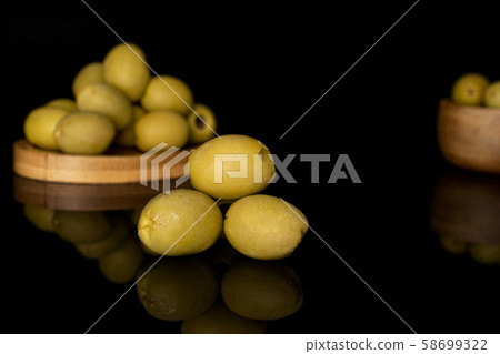 Green marinated olive isolated on black glass Green marinated olive isolated on black glass 58699322
