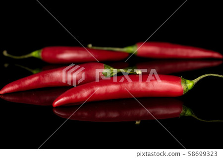 Red hot cayenne chili isolated on black glass Red hot cayenne chili isolated on black glass 58699323