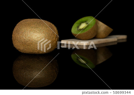 Exotic brown kiwifruit isolated on black glass 58699344