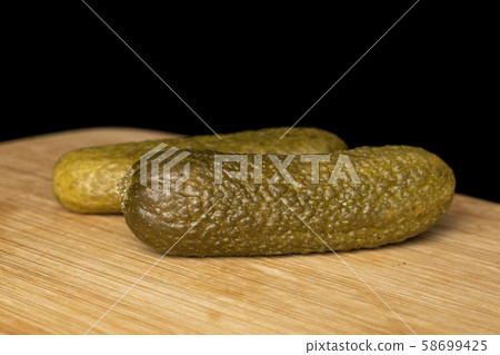 Sour green pickles isolated on black glass 58699425