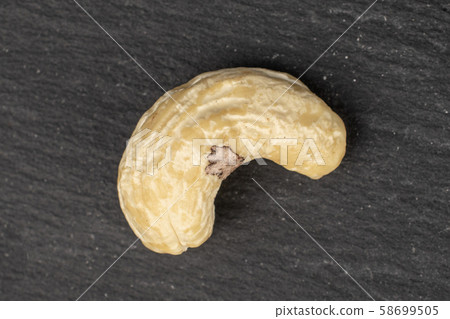 Fresh cashew nut on grey stone Fresh cashew nut on grey stone 58699505