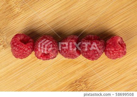 Fresh red raspberry on light wood Fresh red raspberry on light wood 58699508