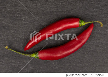 Red hot cayenne chili on grey stone Red hot cayenne chili on grey stone 58699509
