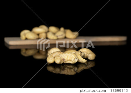 Fresh cashew nut isolated on black glass 58699543