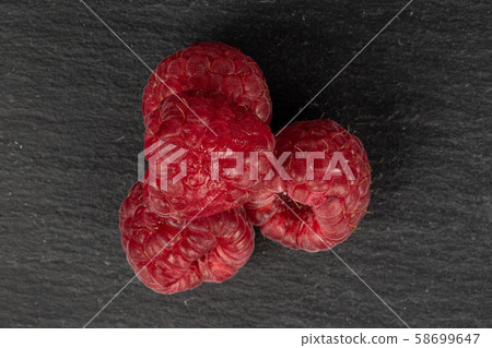 Fresh red raspberry on grey stone 58699647