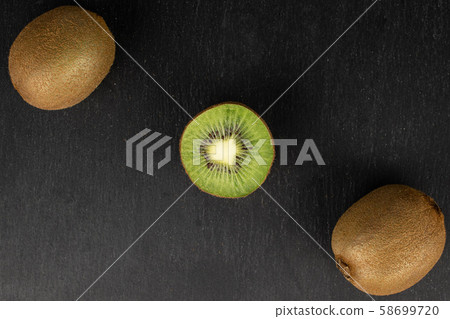 Exotic brown kiwifruit on grey stone 58699720