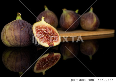 Sweet purple fig isolated on black glass Sweet purple fig isolated on black glass 58699777