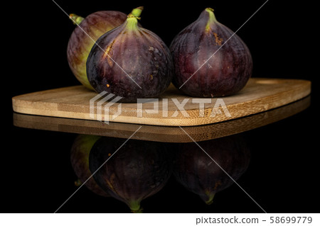 Sweet purple fig isolated on black glass 58699779