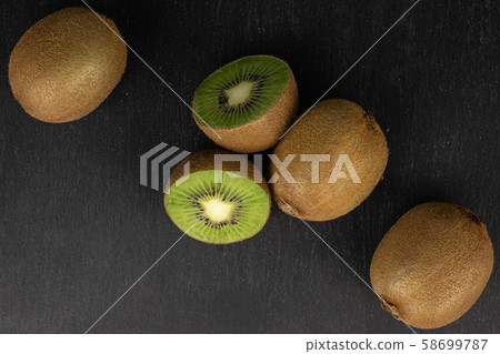 Exotic brown kiwifruit on grey stone Exotic brown kiwifruit on grey stone 58699787