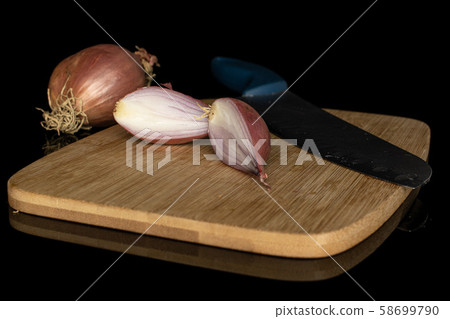 Fresh brown shallot isolated on black glass Fresh brown shallot isolated on black glass 58699790