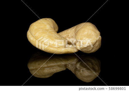 Fresh cashew nut isolated on black glass Fresh cashew nut isolated on black glass 58699801