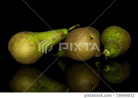 Fresh green pear isolated on black glass Fresh green pear isolated on black glass 58699832