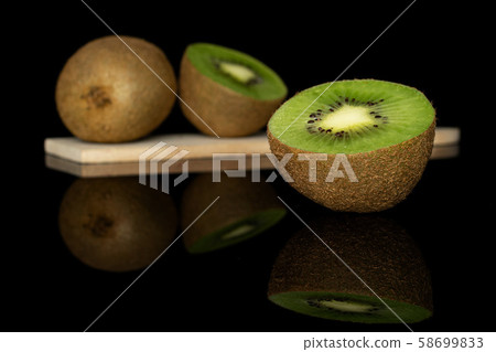 Exotic brown kiwifruit isolated on black glass 58699833