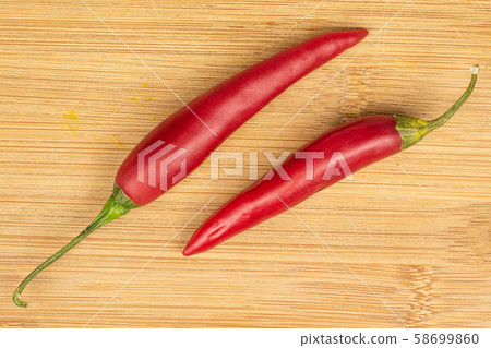 Red hot cayenne chili on light wood Red hot cayenne chili on light wood 58699860