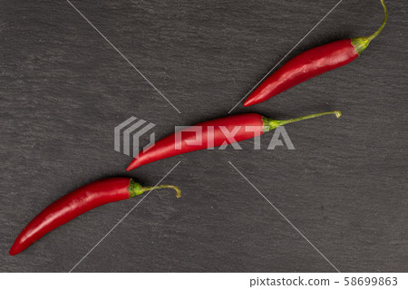 Red hot cayenne chili on grey stone Red hot cayenne chili on grey stone 58699863