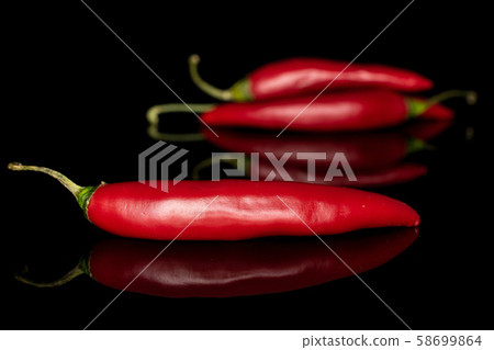 Red hot cayenne chili isolated on black glass Red hot cayenne chili isolated on black glass 58699864