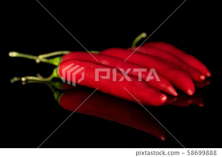Red hot cayenne chili isolated on black glass Red hot cayenne chili isolated on black glass 58699888