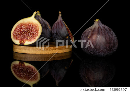 Sweet purple fig isolated on black glass Sweet purple fig isolated on black glass 58699897