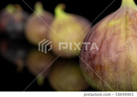 Sweet purple fig isolated on black glass Sweet purple fig isolated on black glass 58699901