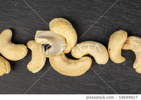 Fresh cashew nut on grey stone Fresh cashew nut on grey stone 58699927