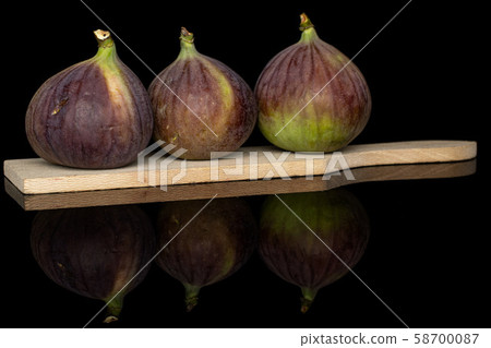 Sweet purple fig isolated on black glass Sweet purple fig isolated on black glass 58700087