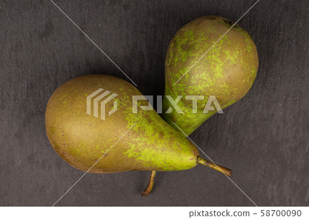 Fresh green pear on grey stone 58700090
