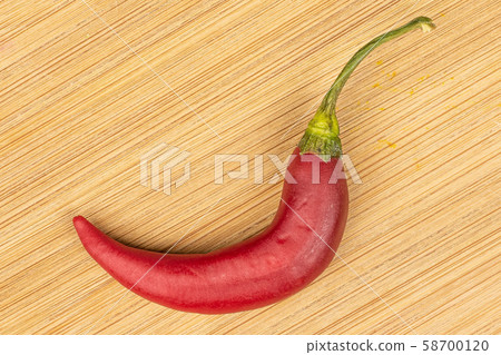 Red hot cayenne chili on light wood Red hot cayenne chili on light wood 58700120