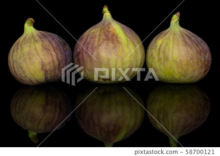 Sweet purple fig isolated on black glass Sweet purple fig isolated on black glass 58700121