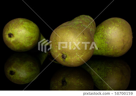 Fresh green pear isolated on black glass Fresh green pear isolated on black glass 58700159