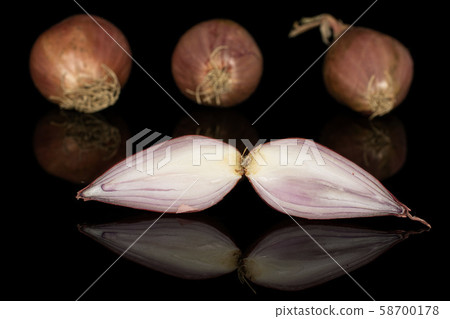 Fresh brown shallot isolated on black glass 58700178