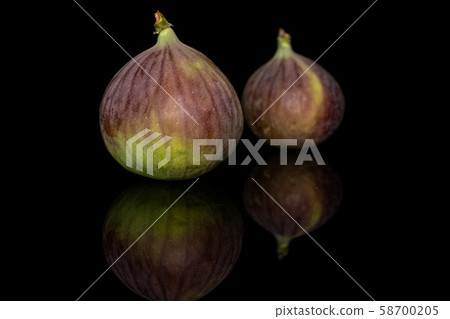 Sweet purple fig isolated on black glass Sweet purple fig isolated on black glass 58700205