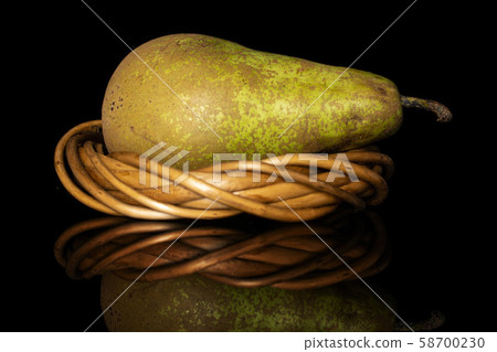 Fresh green conference pear isolated on black glass Fresh green conference pear isolated on black glass 58700230