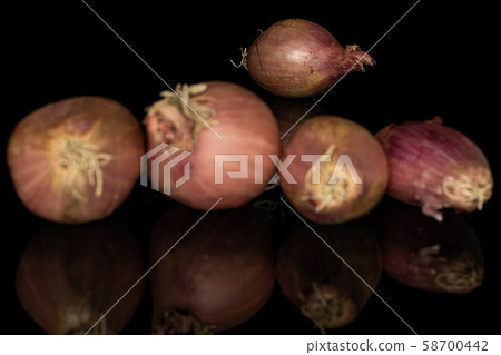 Fresh brown shallot isolated on black glass 58700442