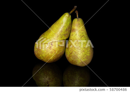 Fresh green conference pear isolated on black glass Fresh green conference pear isolated on black glass 58700486