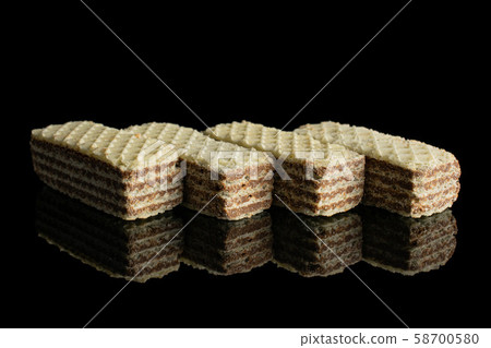 Hazelnut wafer cookie isolated on black glass 58700580