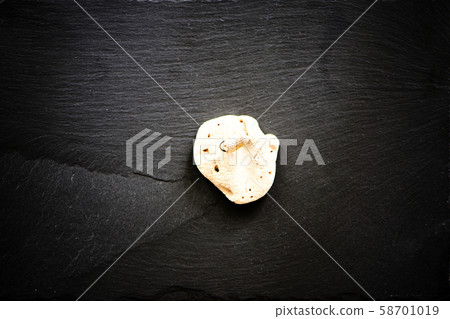 White coral on dark stone background. White coral on dark stone background. 58701019