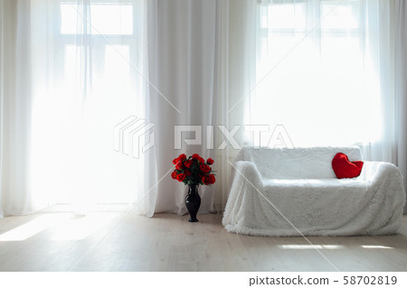 Interior white room sofa flowers light from the window Interior white room sofa flowers light from the window 58702819