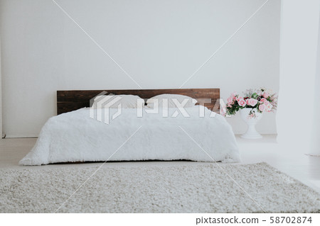 Interior white bedroom this morning with bed 58702874