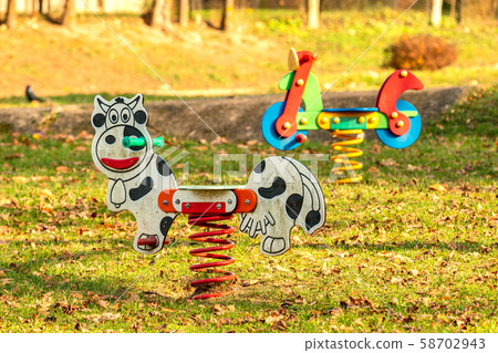 Swings for children on a kids playground 58702943